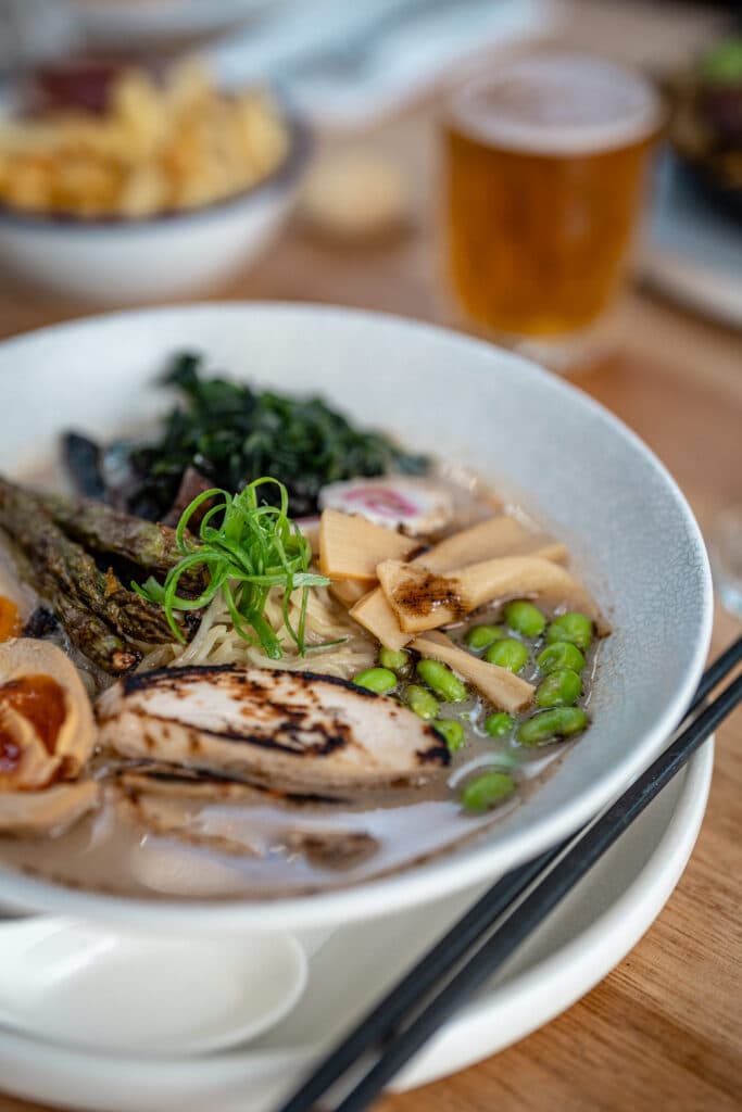 Sliced meat and vegetables in a shallow white bowl