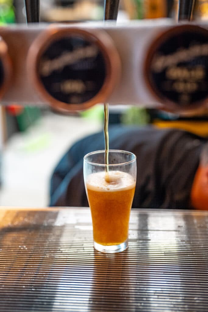 A glass of beer standing on a bar counter