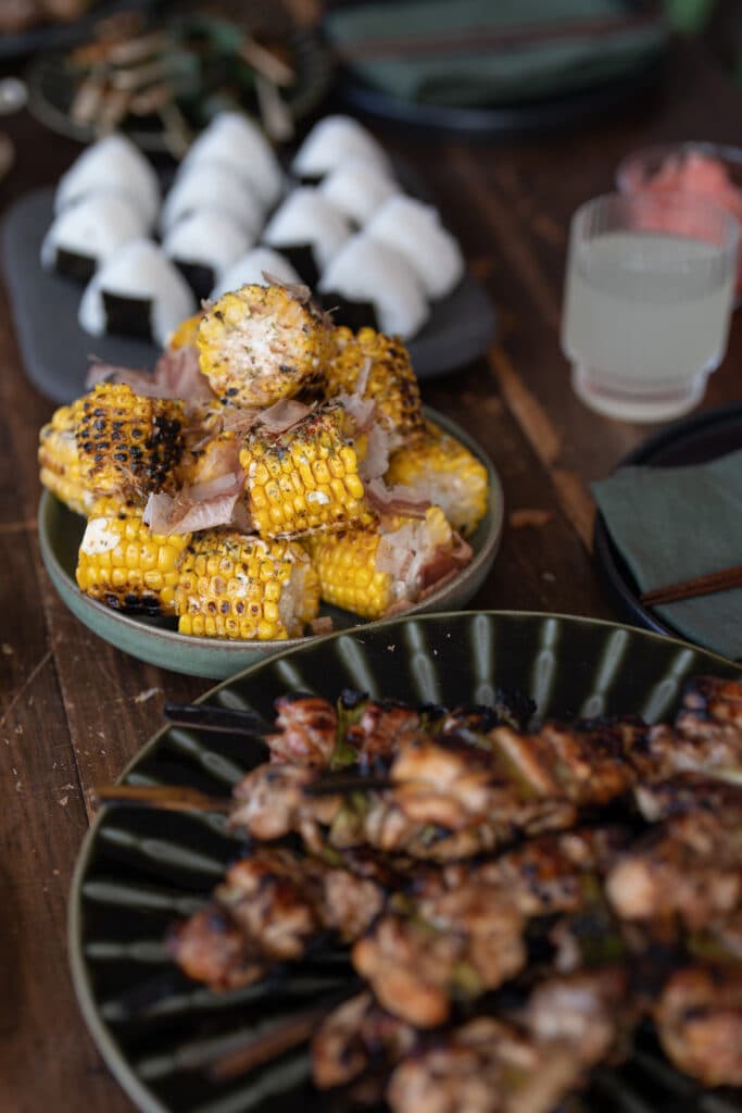 Grilled corn and meat arranged in serving bowls